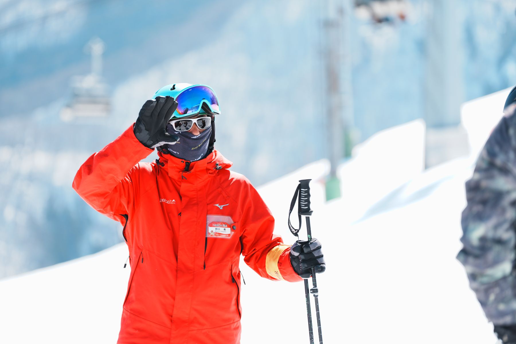 Naeba Ski School coach waving on the slope